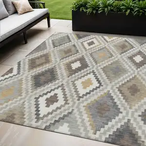 Photo of Taupe Gold And Ivory Geometric Washable Indoor Outdoor Area Rug