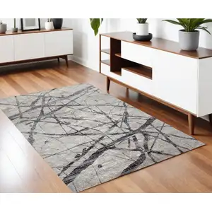 Photo of Taupe Gray And Ivory Abstract Stain Resistant Area Rug