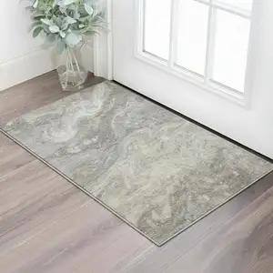 Photo of Taupe Gray And Ivory Abstract Washable Area Rug With UV Protection