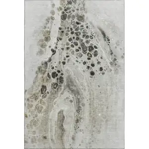 Photo of Taupe Gray And Silver Abstract Washable Area Rug With UV Protection