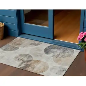 Photo of Taupe Ivory And Beige Abstract Washable Indoor Outdoor Area Rug