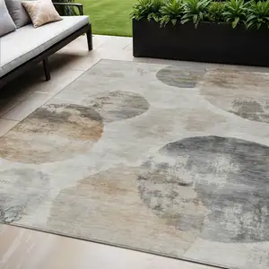 Photo of Taupe Ivory And Beige Abstract Washable Indoor Outdoor Area Rug