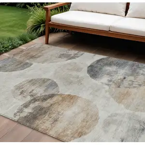 Photo of Taupe Ivory And Beige Abstract Washable Indoor Outdoor Area Rug