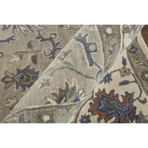 Photo of Taupe Ivory And Blue Wool Floral Tufted Handmade Stain Resistant Area Rug