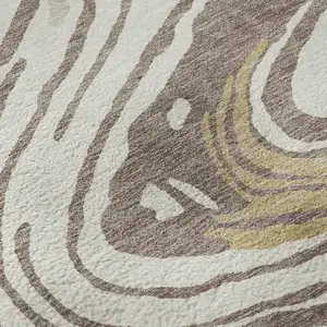 Photo of Taupe Ivory And Gold Abstract Washable Area Rug With UV Protection