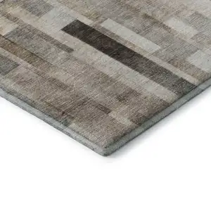 Photo of Taupe Ivory And Gray Striped Washable Area Rug With UV Protection