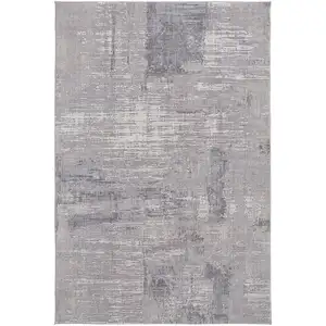 Photo of Taupe Tan And Blue Abstract Power Loom Distressed Stain Resistant Area Rug