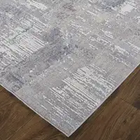 Photo of Taupe Tan And Blue Abstract Power Loom Distressed Stain Resistant Area Rug