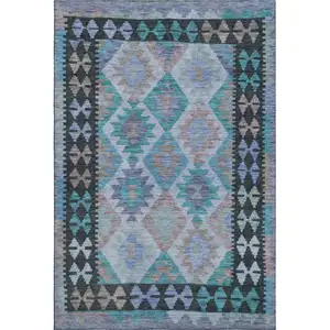 Photo of Teal And Charcoal Tribal Washable Area Rug With UV Protection