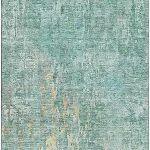 Photo of Teal And Gold Abstract Washable Area Rug With UV Protection