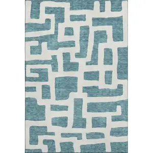 Photo of Teal And Ivory Abstract Geometric Washable Area Rug With UV Protection