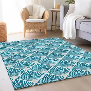 Photo of Teal And Ivory Abstract Geometric Washable Area Rug With UV Protection