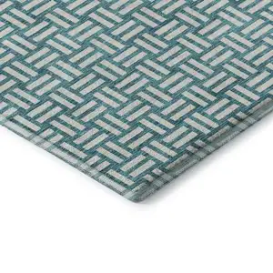 Photo of Teal And Ivory Abstract Geometric Washable Area Rug With UV Protection