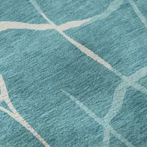 Photo of Teal And Ivory Abstract Geometric Washable Area Rug With UV Protection