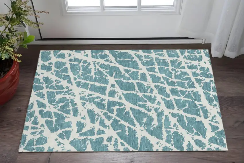 Teal And Ivory Abstract Washable Area Rug With UV Protection Photo 2