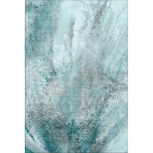 Photo of Teal And Ivory Abstract Washable Area Rug With UV Protection