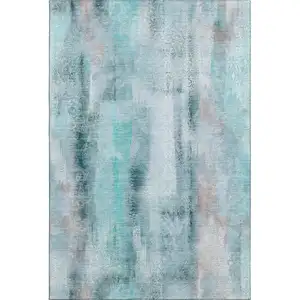 Photo of Teal And Ivory Abstract Washable Area Rug With UV Protection