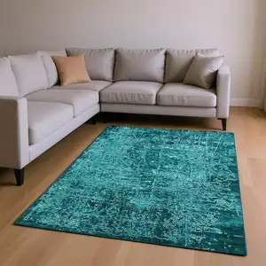 Photo of Teal And Ivory Abstract Washable Area Rug With UV Protection