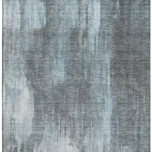 Photo of Teal And Ivory Abstract Washable Area Rug With UV Protection