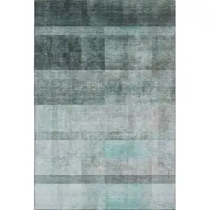 Photo of Teal And Ivory Abstract Washable Area Rug With UV Protection
