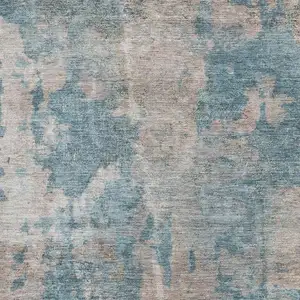 Photo of Teal And Ivory Abstract Washable Area Rug With UV Protection