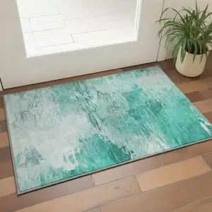 Photo of Teal And Ivory Abstract Washable Area Rug With UV Protection