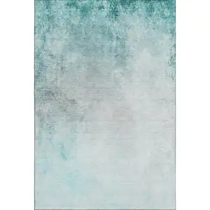 Photo of Teal And Ivory Abstract Washable Area Rug With UV Protection