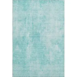 Photo of Teal And Ivory Abstract Washable Area Rug With UV Protection