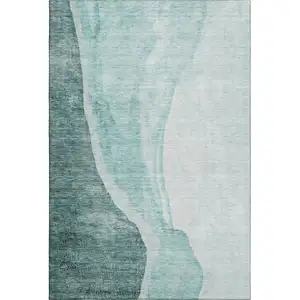 Photo of Teal And Ivory Abstract Washable Area Rug With UV Protection