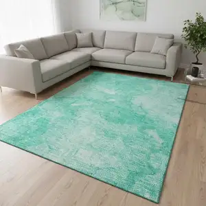 Photo of Teal And Ivory Abstract Washable Area Rug With UV Protection