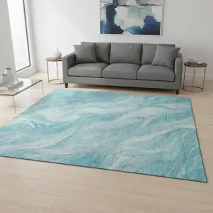 Photo of Teal And Ivory Abstract Washable Area Rug With UV Protection