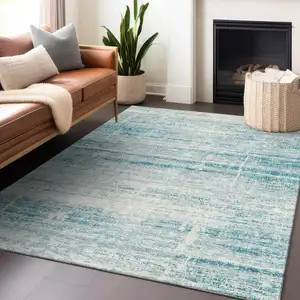 Photo of Teal And Ivory Abstract Washable Area Rug With UV Protection