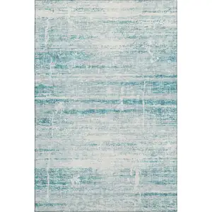 Photo of Teal And Ivory Abstract Washable Area Rug With UV Protection