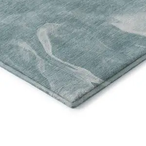Photo of Teal And Ivory Abstract Washable Area Rug With UV Protection