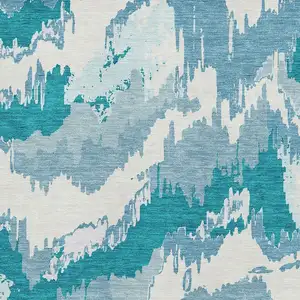 Photo of Teal And Ivory Abstract Washable Area Rug With UV Protection