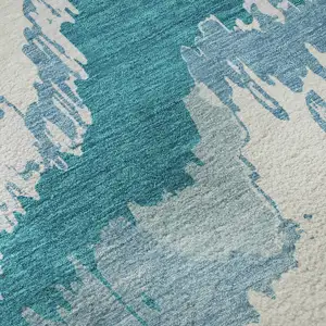 Photo of Teal And Ivory Abstract Washable Area Rug With UV Protection