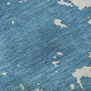 Photo of Teal And Ivory Abstract Washable Area Rug With UV Protection