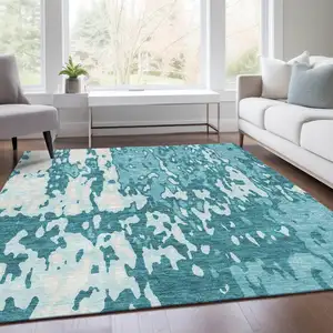 Photo of Teal And Ivory Abstract Washable Area Rug With UV Protection