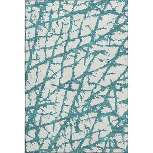 Photo of Teal And Ivory Abstract Washable Area Rug With UV Protection