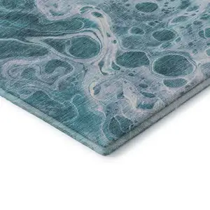 Photo of Teal And Ivory Abstract Washable Area Rug With UV Protection