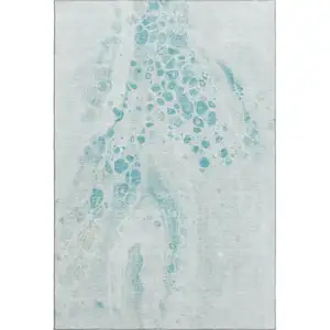 Photo of Teal And Ivory Abstract Washable Area Rug With UV Protection