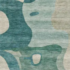 Photo of Teal And Ivory Abstract Washable Area Rug With UV Protection