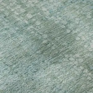Photo of Teal And Ivory Abstract Washable Area Rug With UV Protection