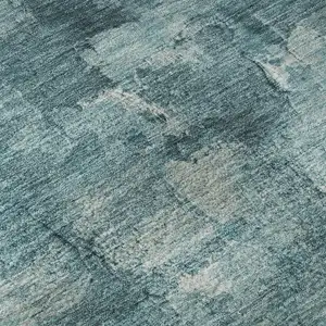 Photo of Teal And Ivory Abstract Washable Area Rug With UV Protection