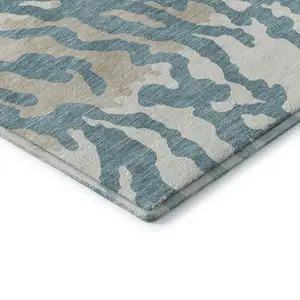 Photo of Teal And Ivory Animal Print Washable Area Rug With UV Protection