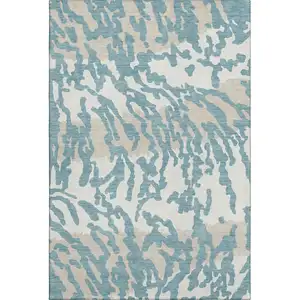 Photo of Teal And Ivory Animal Print Washable Area Rug With UV Protection