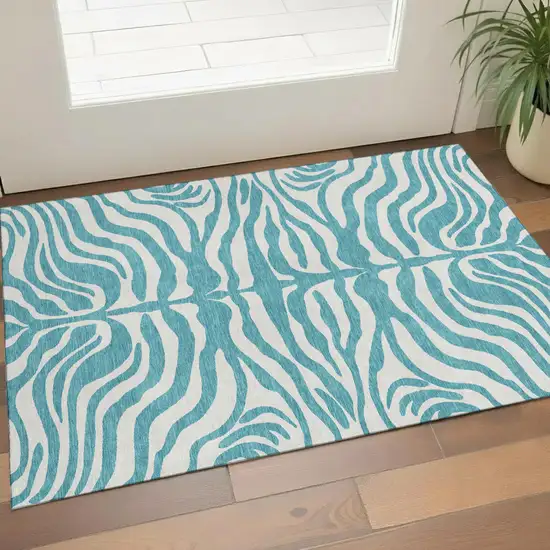 Teal And Ivory Animal Print Washable Area Rug With UV Protection Photo 1