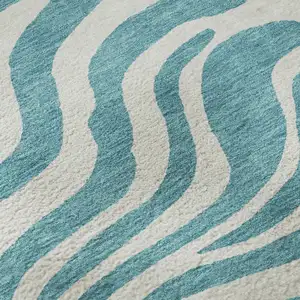 Photo of Teal And Ivory Animal Print Washable Area Rug With UV Protection