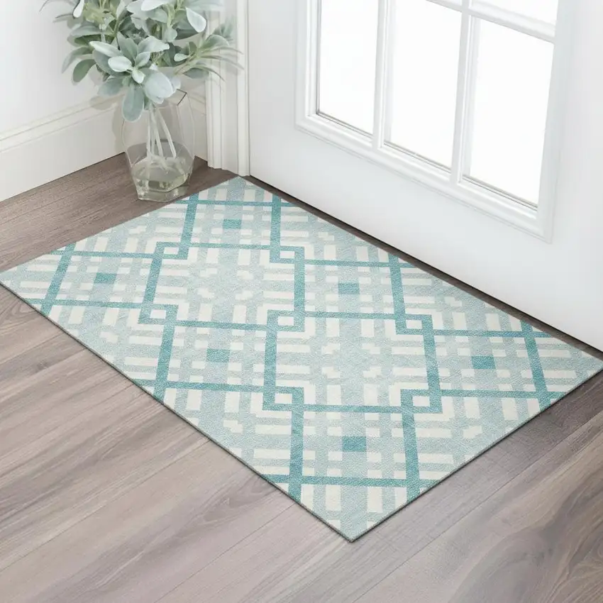 Teal And Ivory Geometric Washable Area Rug With UV Protection Photo 1