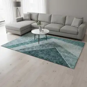 Photo of Teal And Ivory Geometric Washable Area Rug With UV Protection